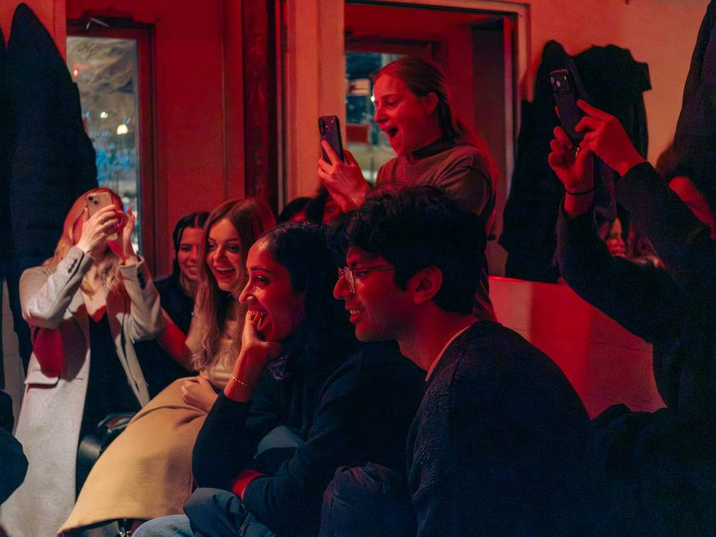 Guests reacting in astonishment during a close-up magic performance